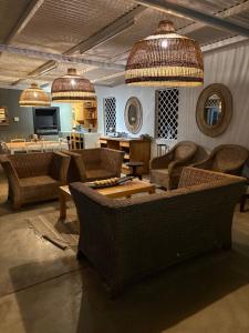 a living room with couches and a table and chairs at Silver Linings Cottage in Parys