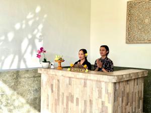 two people sitting at a counter in a room at Pulu Sari Suite Ubud in Ubud +24 photos