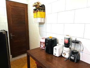 a table with appliances on it in a kitchen at Pulu Sari Suite Ubud in Ubud