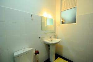 a bathroom with a sink and a toilet and a mirror at City Stay in Galle +50 photos