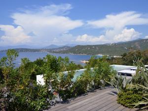 a wooden deck with a view of a body of water at Dililodge in Verghia