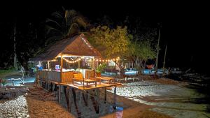 a small cabin with lights on it at night at Sau Baryam in Fam