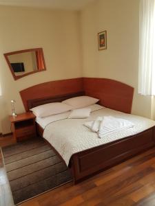 a bedroom with a bed and a mirror on the wall at Hotel Restauracja Kinga in Katowice