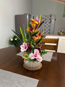 a vase filled with flowers on a table at Soulful Serenity in Steer Town