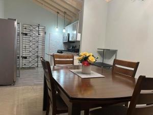 a dining room table with a vase of flowers on it at Soulful Serenity in Steer Town