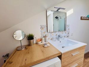 a bathroom with a sink and a mirror at Cocon Savoyard - Vues Alpes - 2 king size - Rando & VTT - Parking in Albertville +19 photos