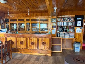 a library with wooden cabinets and a book shelf at Sunshine lodge in Namche