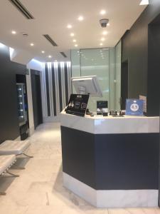 a lobby with a reception desk in a building at Hotel Sitges in Sitges