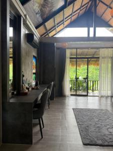 a dining room with a long table and chairs at Namkhan Rivora Resort in Luang Prabang