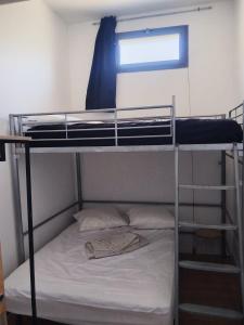 two bunk beds in a room with a window at cardo village in Bastia