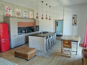a kitchen with an island in the middle of a room at cardo village in Bastia