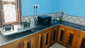 a kitchen with a counter with a television on it at RL Holiday Inn in Jaffna