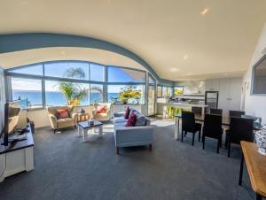 an open living room with a view of the ocean at Pierview Apartments in Lorne