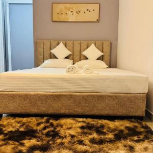 a bedroom with a large bed with white sheets and pillows at Boom Town Villa - Anuradhapura in Anuradhapura