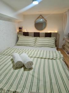 a bedroom with a large bed with towels on it at Cozy Loft Studio with Balcony in Cebu City in Cebu City +25 photos