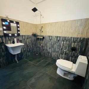a bathroom with a toilet and a sink at Boom Town Villa - Anuradhapura in Anuradhapura +23 photos