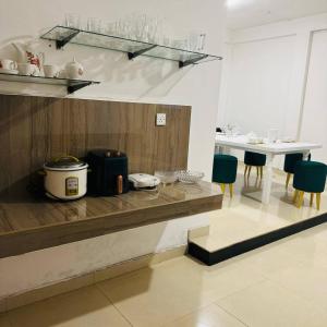 a kitchen with a counter and a table with chairs at Boom Town Villa - Anuradhapura in Anuradhapura