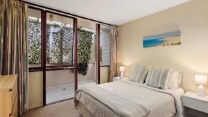 a bedroom with a bed and a window at Quirky and Captivating Kurra in Hawks Nest