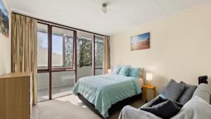a bedroom with a bed and a couch at Quirky and Captivating Kurra in Hawks Nest +11 photos