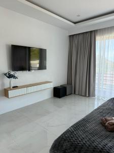 a bedroom with a flat screen tv and a bed at Villa Fiesta, 5bd, palace in Mae Nam