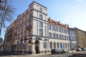 a large building on the corner of a street at Hotel Racibor in Racibórz