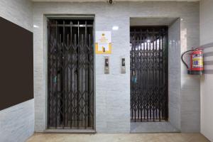a building with two iron gates on a wall at Itsy Hotels Grand CG in Ahmedabad