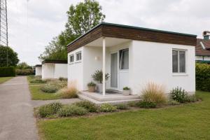 a white house with a brown roof at Ausee Lodges Blindenmarkt in Blindenmarkt