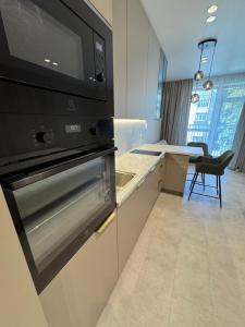 a kitchen with a stove and a microwave at S14 Apartment in Vilnius