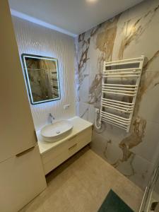 a bathroom with a sink and a mirror at S14 Apartment in Vilnius