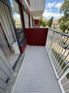 a balcony with a red and white walkway at S14 Apartment in Vilnius +3 photos