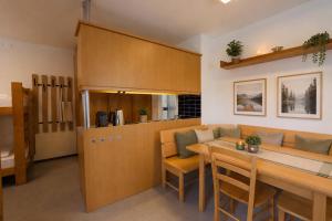 a kitchen and living room with a table and a couch at Ausee Lodges Blindenmarkt in Blindenmarkt