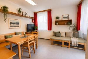 a living room with a couch and a table at Ausee Lodges Blindenmarkt in Blindenmarkt +6 photos