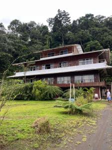 a large building with a person standing in front of it at Villa Encanto in Bahía Solano +24 photos
