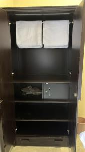 a black shelf with two towels on top of it at DownTown INN in Manendragarh