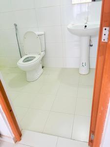 a bathroom with a toilet and a sink at Villa 64 - Airport Transit in Katunayaka