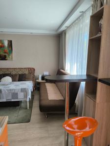 a room with a table and a couch and a bed at Family Apartament in Narva-Jõesuu +3 photos