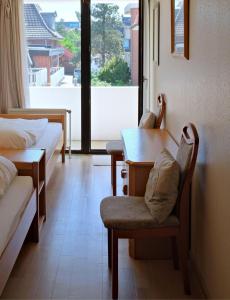 a room with two beds and a table and chairs at Germania-36 in Böhl +9 photos