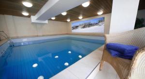 a swimming pool with a tv on the wall at Germania-36 in Böhl