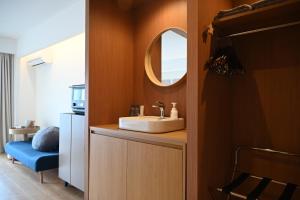 a bathroom with a sink and a mirror at Yolo Hotel 最寄駅徒歩1分 Askusa 秋葉原 スカイツリー近く 東京観光に最適 空港アクセス良好 in Tokyo +37 photos
