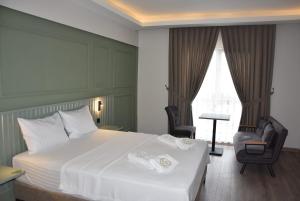a hotel room with a bed and two chairs at Görele Liva Otel in Görele +72 photos