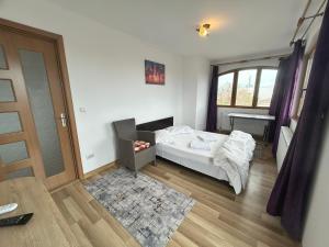 a bedroom with a bed and a window and a door at Apartaments Doriana in Vama Veche