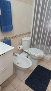 a bathroom with a toilet and a sink and a shower at Perla del mare Ionio in Fondachello +10 photos