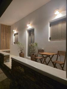 a patio with a table and chairs and lights at Le Blé Home in Mérikhas +15 photos