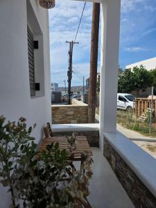 a porch with a bench and a view of a street at Le Blé Home in Mérikhas