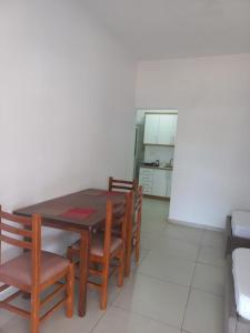 a dining room with a wooden table and chairs at Anna! in Ksamil +5 photos