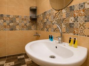 a bathroom with a white sink and a mirror at Pyramids Front Gate Hotel in Cairo +43 photos