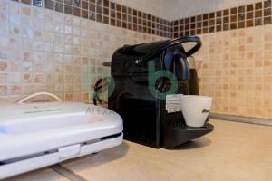 a toaster sitting on a counter with a cup in it at Thea Dikella in Dhíkella +75 photos