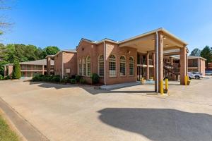 a large brick building with a parking lot at Super 8 by Wyndham Acworth/Atlanta Area in Acworth