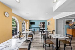 a row of tables and chairs in a restaurant at Super 8 by Wyndham Acworth/Atlanta Area in Acworth