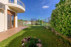 a yard of a house with a fence at Thea Dikella in Dhíkella